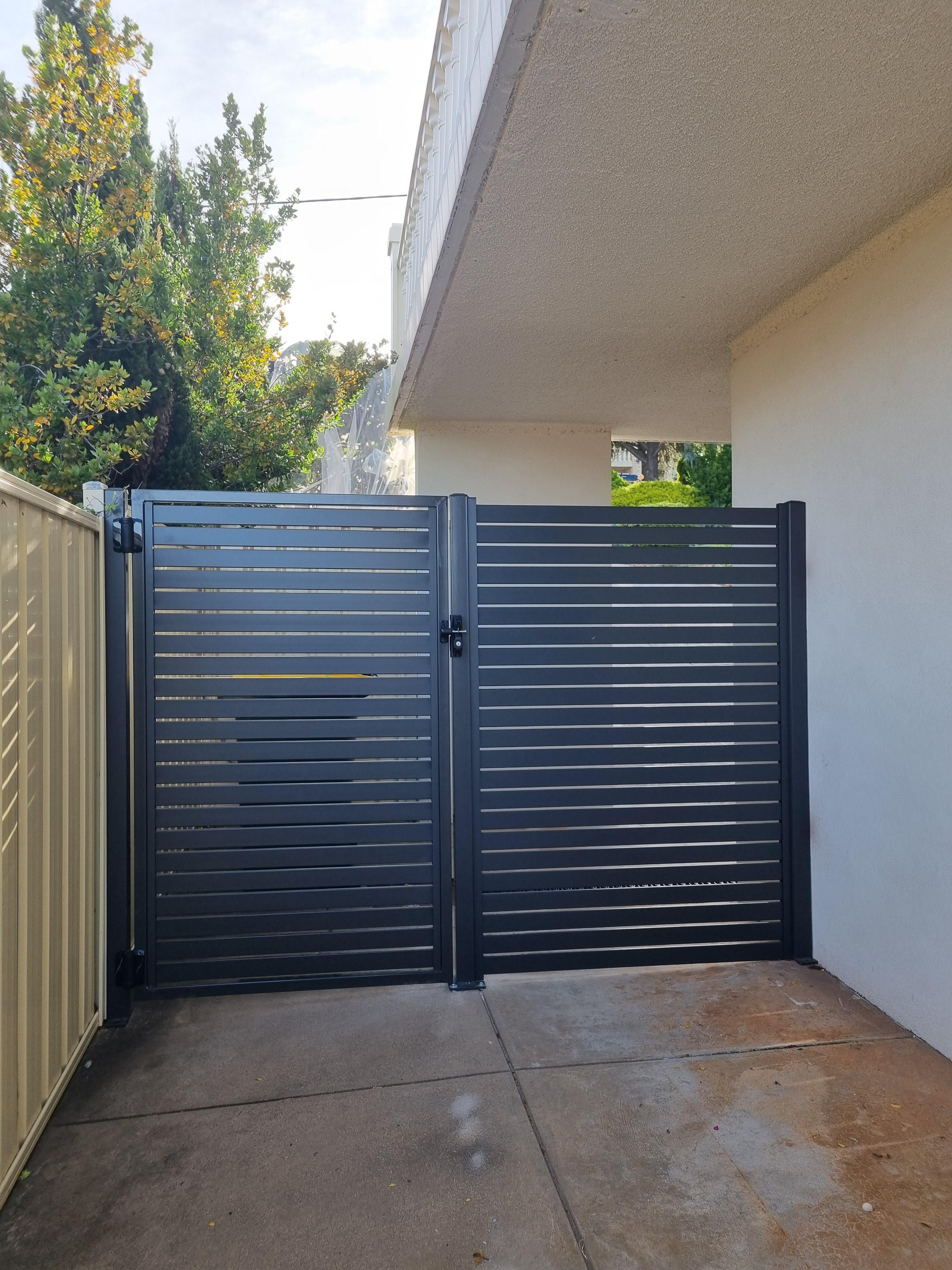 A side access gate fitted beside a house