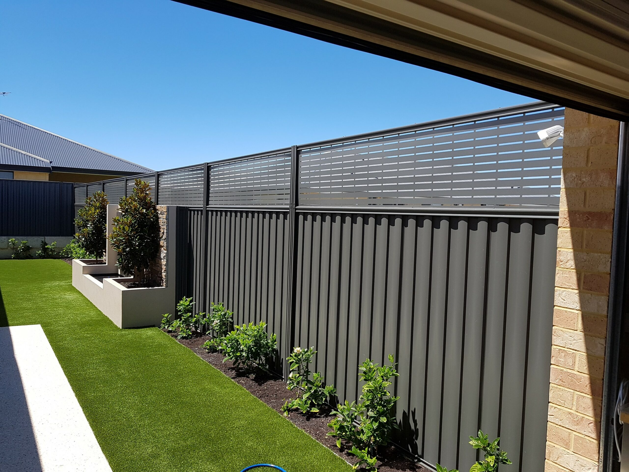 A newly installed good neighbour fence beside a residential driveway