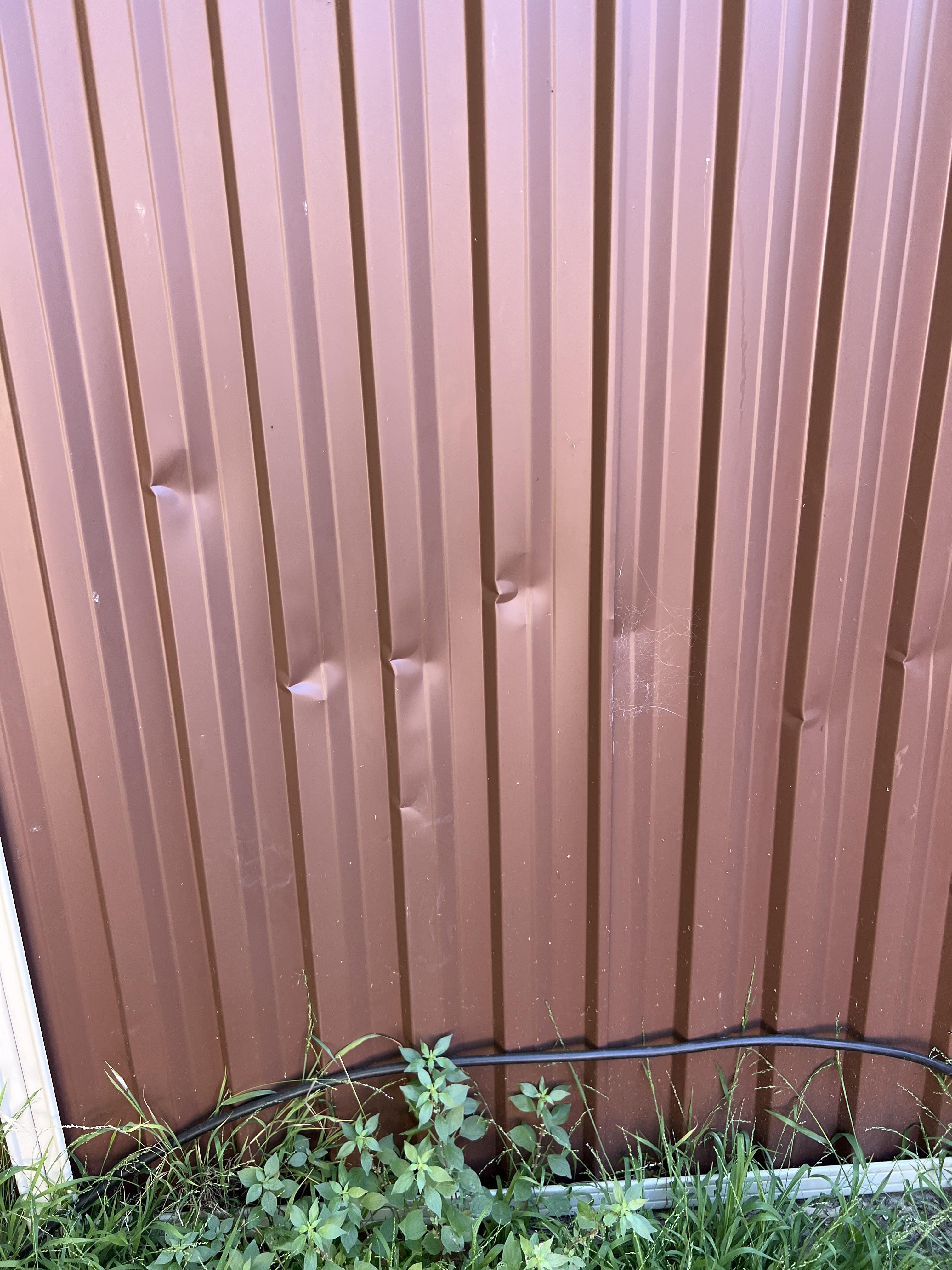 A repaired timber fence after storm damage